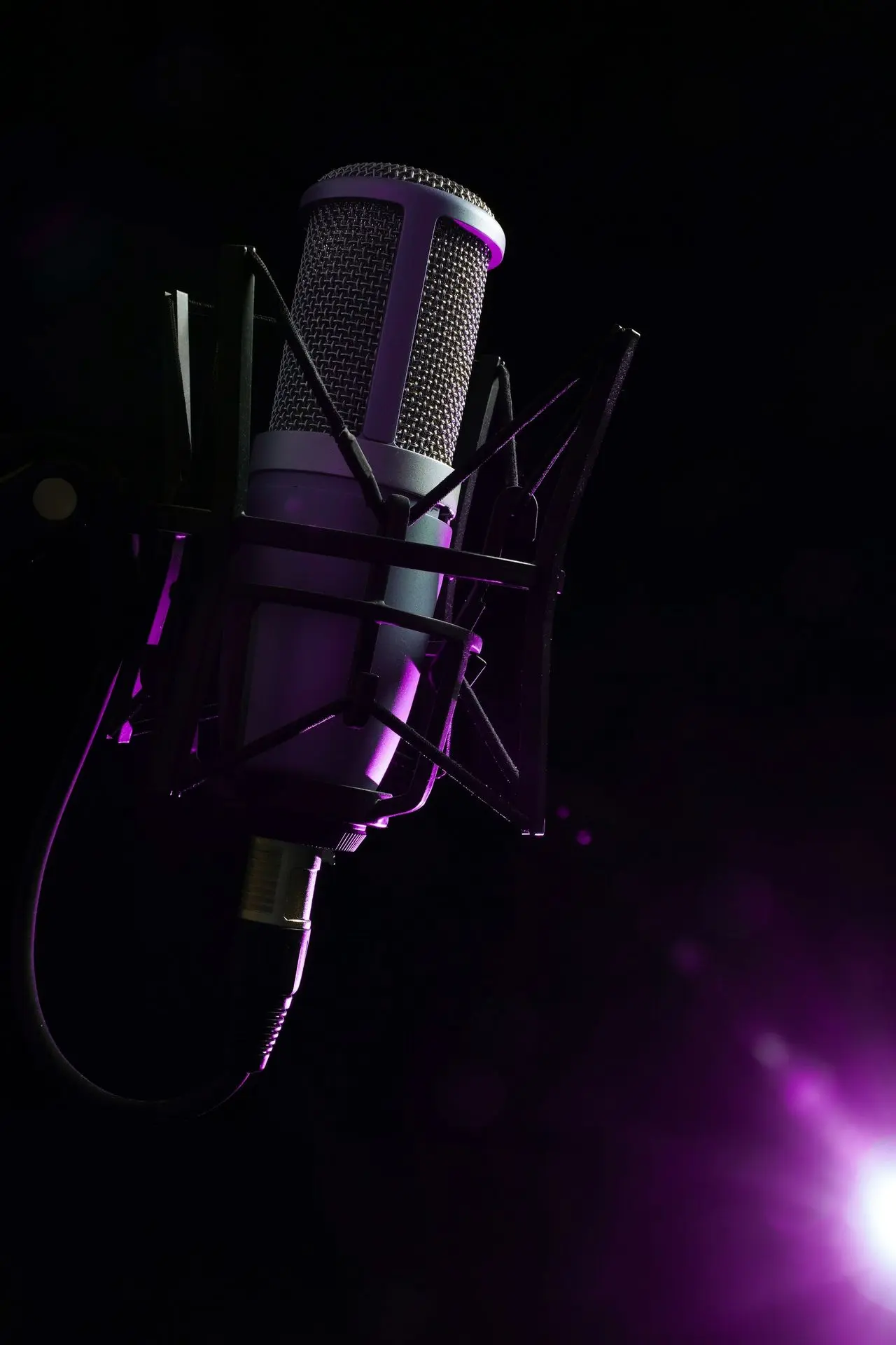 a microphone with a purple light behind it